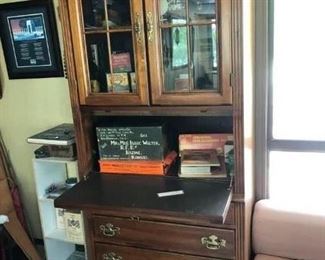 Glass Door secretary/cabinet with 3 bottom drawers.  It is Hooker and matches the two bookcases.  Drop down desk.   $399.00