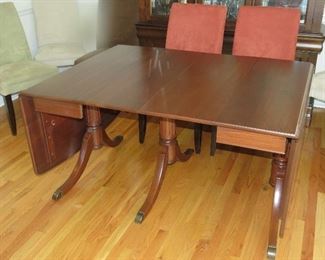 Beautiful dropleaf walnut dining table with 8 chairs.