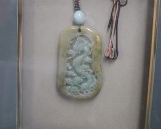 Hanging jade pendant with dragon theme.