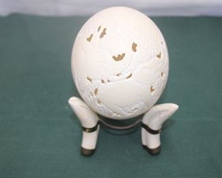 $50. Ostrich egg with carvings of elephant family around it. Stands on three wart hog tusks.