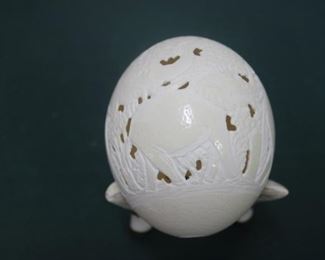 $50. Ostrich egg with carvings of elephant family around it. Stands on three wart hog tusks.