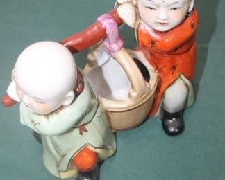 50% OFF, now $10.                                                                          
$20. Unsigned Asian porcelain water carrying figures. No chips or damage. 10 inches tall.
