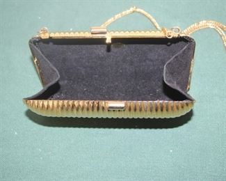 $10. Gold colored metal clutch with shoulder strap.
