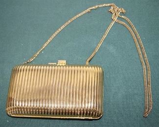 $10. Gold colored metal clutch with shoulder strap.