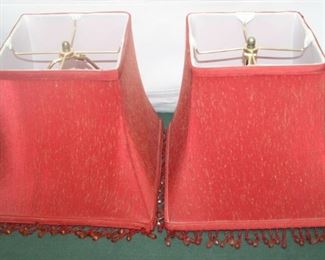 $20. Pair of 10" high red beaded lampshades with harps attached.
