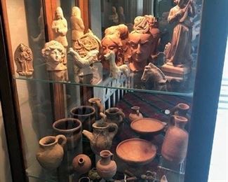 Ming tomb offerings, Asian artifacts, Roman oil lamps and other items in display cabinet.
