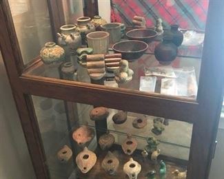 Ming tomb offerings, Asian artifacts, Roman oil lamps and other items in display cabinet.