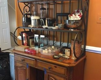 Bakers rack with appliances and kitchen items.