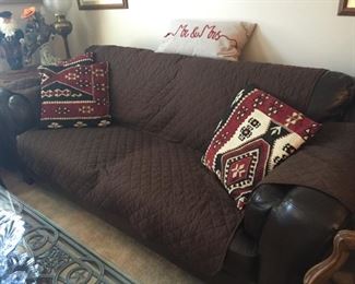 Bob's foam sleeper sofa with cover and pillows.