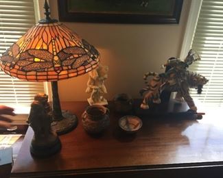 Tiffany style lamp and Asian sculptures.