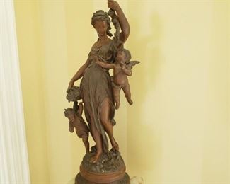 Antique poly-chrome white metal figure of a woman and children