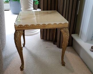 One of two onyx top side tables