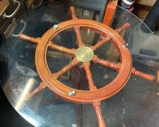 Small Nautical Table with ship’s wheel
                  Glass Top 25.5” D, Ship’s wheel 23”D
	        Pedestal base 26.25”H
$125