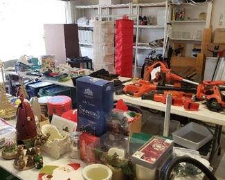 garage has a mix of items, including tools and Christmas, freezer and refrigerator