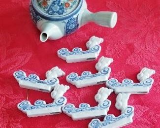 LOT S130 - $12 - EIGHT PIECE CHOPSTICK RESTS WITH TEAPOT