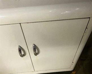 32. Vintage White Metal Kitchen/Storage Cabinet. Needs a little TLC on the top. Measures 25 Wide, 12 Depth, 26 Height $49