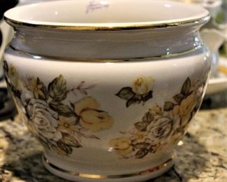 Hand painted floral china is exquisitely detailed.  With gold banding.