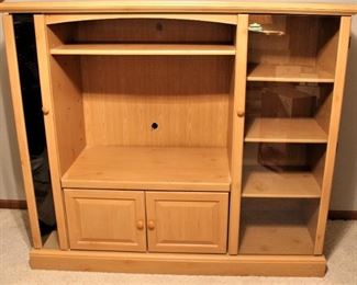 Very, very nice entertainment center with side storage for games and movies.