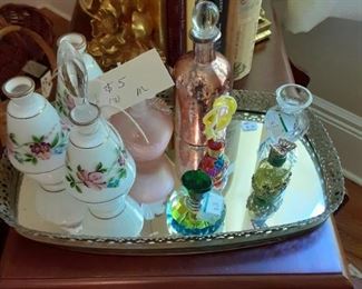 Perfume bottles, mirrored tray, bookends, books