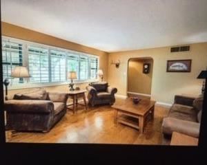 Front room: Couch, two chairs, 3 lamps, electric fireplace insert