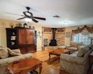 Family room: Couch, love seat, chair w/ ottoman, Entertainment center with two matching bookshelves, coffee table, two end tables, two lamps