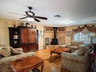 Family room: Couch, love seat, chair w/ ottoman, Entertainment center with two matching bookshelves, coffee table, two end tables, two lamps
