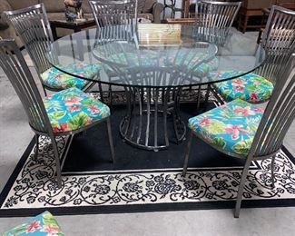 60” round glass and brushed steel table and 6 chairs 600.00