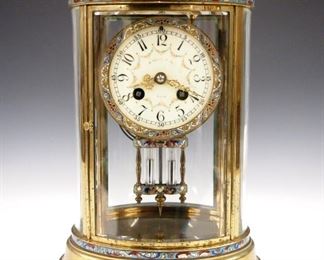 A turn of the century French crystal regulator with Cloisonne detail by L. Marti, Paris originally retailed by "A. Stowell & Co. Inc., Boston".  8-day time and strike movement with a painted flat porcelain dial and Arabic numerals, fancy gilded hands and faux mercury pendulum.  Oval brass case with beveled glass panels.  Minor wear, running when cataloged.  11" high.  ESTIMATE $300-500