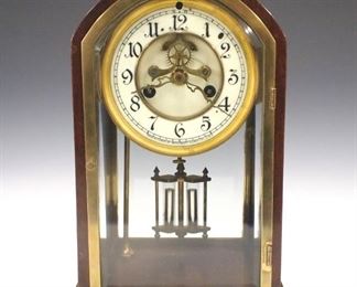 An early 20th century Waterbury "Lozere" model wood cased crystal regulator.  8-day time and strike movement with two part porcelain dial and Arabic numerals, visible escapement and faux mercury pendulum.  Mahogany case with brass doors and beveled glass panels.  Minor wear, running when cataloged.  10 3/4" high.  ESTIMATE $200-300