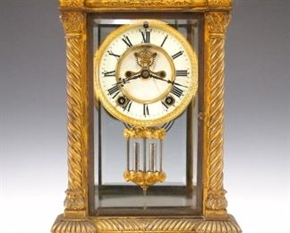 A turn of the century Ansonia "Don" model crystal regulator.  8-day time and strike movement with two part porcelain dial and Roman numerals, visible escapement and faux mercury pendulum.  Gilded Bronze case with beveled glass panels.  Case wear, hairlines in dial, running when cataloged.  13" high.  ESTIMATE $200-300