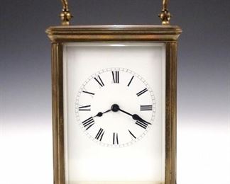 A turn of the century French carriage clock.  8-dat time and strike movement with porcelain dial and Roman numerals.  Molded brass case with beveled glasses.  Minor wear, tiny flake in rear glass, winds, sets and running when cataloged.  5 3/4" high overall.  ESTIMATE $200-300