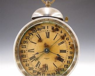 An early 20th century New Haven calendar alarm clock.  30 hour movement with paper dial and simple calendar in a nickel case.  Wear, staining on dial, winds sets and running when cataloged.  6 1/2" high.  ESTIMATE $50-75