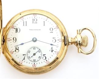 An American Waltham Watch Company 14k Gold "Lady Waltham" pendant watch.  0 size, 16 j, ADJ, GJS, DMK, SW, PS, in a 14k  Gold fancy engraved HC, SSD w/Arabic numerals.  Serial # 15,0233,922.  Slight wear, engraved cuvette "Mary F. Cooke, 1908", winds, sets, not running when cataloged. ESTIMATE $300-400