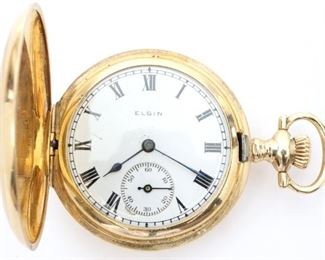 An Elgin National Watch Company 14k Gold ladies pendant watch.  3/0 size, 15 j, DMK, DR, SW, PS, in a 14k Gold fancy engraved Keystone case HC, SSD w/Roman numerals.  Serial # 19662149.  Slight wear, hairline in dial, wound tight, not running when cataloged. ESTIMATE $600-800