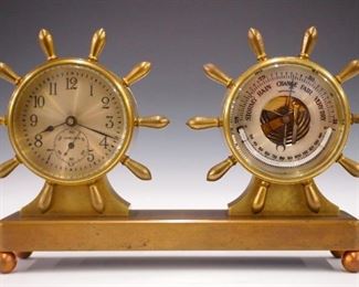 An early 20th century Chelsea "Fulton" model desk clock with barometer and thermometer.  8-day time only movement with silvered dial and Arabic numerals.   Bronze case with double ship's wheel design and ball feet.  Old finish with some wear, running when cataloged.  5 3/4" high overall.  ESTIMATE $200-300