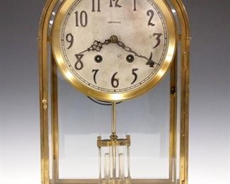 A 1920's Seth Thomas "Crystal Doric No. 2" model shelf clock.  14-day time and strike movement with silvered dial and Arabic numerals and faux mercury pendulum.  Brass arched top case with beveled glass panels and bracket feet.  Minor case wear, tarnish on dial, running when cataloged.  14" high.  ESTIMATE $200-400