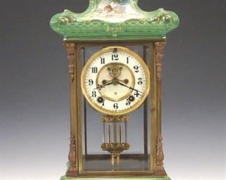 A turn of the century Ansonia "Porcelain Regulator No. 2" model crystal regulator with porcelain top and base.  8-daytime and strike movement with two part porcelain dial, Arabic numerals, visible escapement and faux mercury pendulum.  Brass case with cast columns and beveled glass panels, porcelain top and base decorated with cherubs and flowers. Slight wear, running when cataloged.  18" high.  ESTIMATE $800-1,200