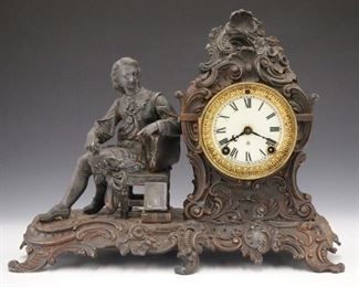 A turn of the century Ansonia "Author" model shelf clock.  8-day time only movement with porcelain dial and Roman numerals.  Cast Spelter case with scrollwork and floral  decoration.  Surface wear, finish loss, running when cataloged.  11" high.   ESTIMATE $100-150