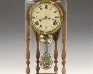 A late 19th century E. N. Welch "Crystal Palace" parlor clock.  8-day time and strike movement with papered dial and Roman numerals.  Walnut case with turned columns and base under a glass dome.  Old finish with some wear, brass tarnished, running when cataloged.  18 1/2" high overall.  ESTIMATE $200-300