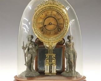 A late 19th century Ansonia "Crystal Palace No. 1 Extra" parlor clock.  8-day time and strike movement with papered dial and Roman numerals.  Walnut case with spelter figures and molded base under a glass dome.  Old finish with some wear, dial discoloration, running when cataloged.  18" high overall.  ESTIMATE $400-600