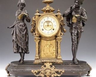 A turn of the century Ansonia "Vocalists" model figural clock.  8-day time and strike movement with two part porcelain dial and Roman numerals with visible escapement.  Cast Spelter case with double figures and central clock above a Bronze plaque.  Original finish with wear and some loss to the Japanning, running when cataloged.  21 3/4" high.   ESTIMATE $800-1,200