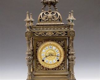 A turn of the century Ansonia "Regent" model table clock.  8-day time and strike movement with gilded Bronze dial and porcelain Roman numerals.  Cast Spelter case with extensive pierced detail on all four sides.  Original finish with minor wear, top finial glued, running when cataloged.  21 1/2" high.   ESTIMATE $800-1,200