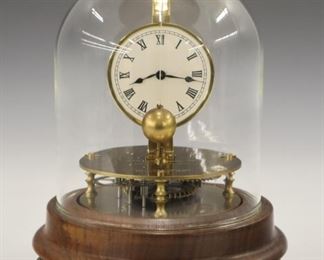 A late 20th century Horolovar reproduction of a Briggs Rotary clock.  8-day time only brass movement on a Walnut base with cast paw feet.  Minor wear, running when cataloged.  7" high overall.   ESTIMATE $200-300