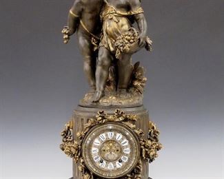 A turn of the century Ansonia "Florida and Group No. 1089" model figural clock.  8-day time and strike movement with two part cast dial and porcelain Roman numerals with visible escapement.  Cast Spelter case with figures of two young children.  Older refinishing with minor wear,  running when cataloged.  29" high.   ESTIMATE $1,000-1,500