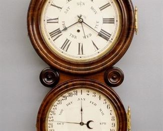 A late 19th century Ingraham "Ionic" model figure 8 calendar wall clock.  8-day time and strike movement with lower "B. B. Lewis" calendar mechanism and papered metal dials.  Figure "8" case with molded upper and lower doors with oversized Brass hinges and original grain painted finish.  Some finish wear and touchups, dials re-papered, running when cataloged.  29 3/4" high.  ESTIMATE $400-600