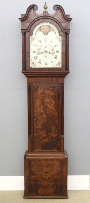 A 19th century British grandfather clock.  Mahogany case with classic broken arch top with fluted and carved columns in the hood, shaped molded waist door, fluted quarter columns and a molded base.  8-day, weight driven time and strike movement with a painted iron dial marked "Jn. B Booth, Manchester" having an upper moon phase aperture.  Older refinishing with wear and some older restoration, some flaking on dial, running when cataloged.  88" high overall.  ESTIMATE $800-1,200