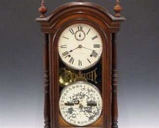 A late 19th century Southern Calendar Clock Co. "Fashion No. 4" model parlor clock.  8-day time and strike Seth Thomas movement with recessed seconds bit and lower calendar mechanism, painted metal dials with Roman/Arabic numerals.  Walnut case with arched molded cornice above a single door with painted "Fashion" glass flanked by turned columns on a molded base.  Old finish with wear, minor veneer damage, replaced finials, some dial wear, flaking on calendar dial, running when cataloged.  32" high.  ESTIMATE $800-1,200