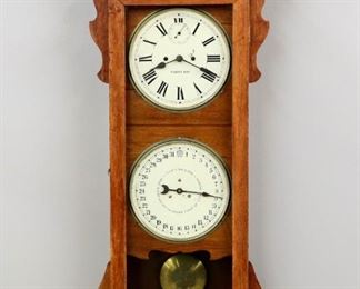 A late 19th century New Haven "Rutland" model calendar wall clock.  Thirty day double spring time only movement with painted metal dial, Roman numerals and lower simple calendar mechanism.  Oak case with a shaped crest and applied carving over a single long door and shaped drop.  Original finish with minor wear, slight flaking to dials, running when cataloged.  47" high.  ESTIMATE $600-800
