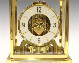 A 20th Century LeCoultre "Atmos" Clock.  Fifteen jewel Calibre 528-6 perpetual mechanism powered by atmospheric pressure.  Brass case with glass panels.  White chapter ring with Arabic numerals.  Serial #168424.  Minor case wear, glue residue on base, running when cataloged.  9 1/4" high.  ESTIMATE $300-500