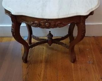 #50 marble top hand carved wood table 37 long 37.5 tall and 26 inches deep. $120